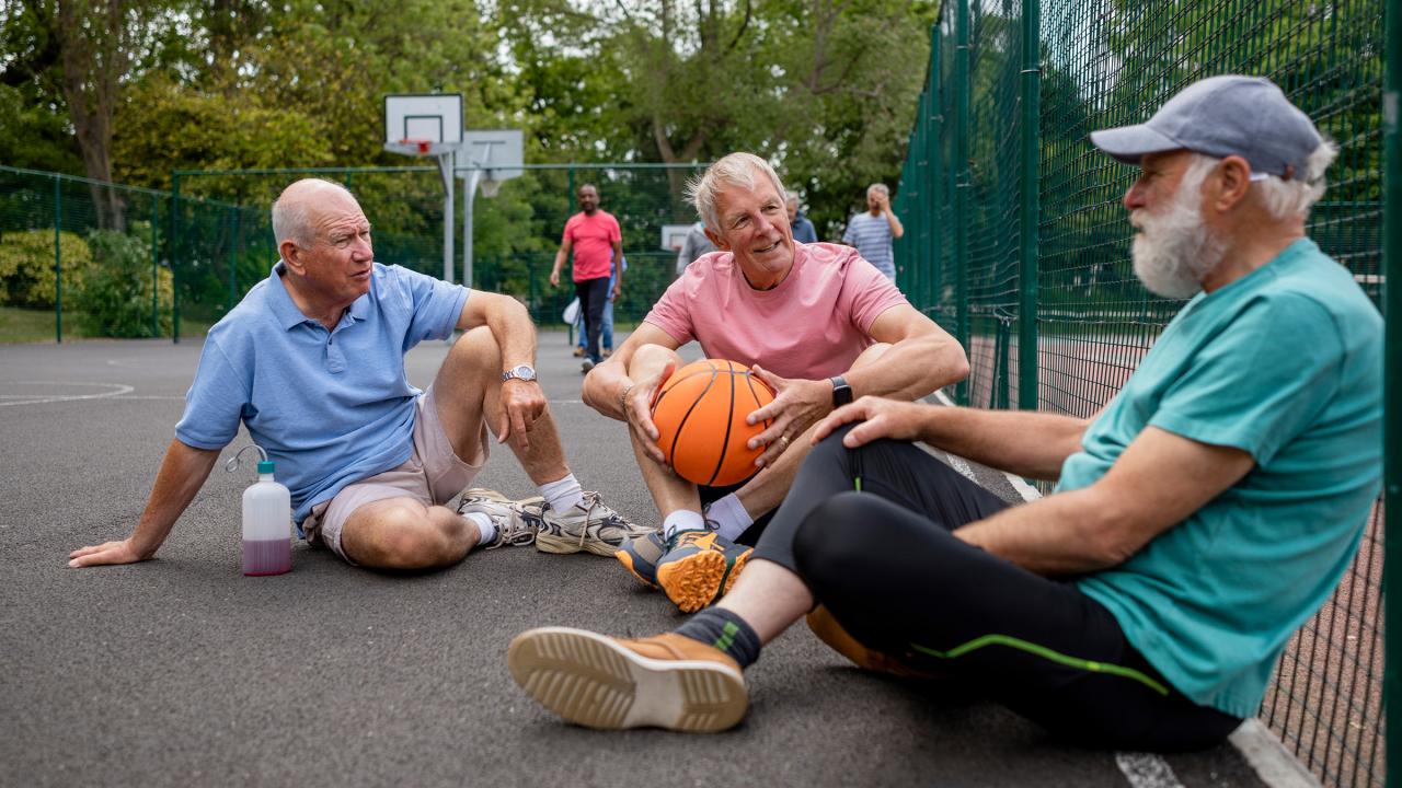 Ouderen zitten op de grond op sportveld